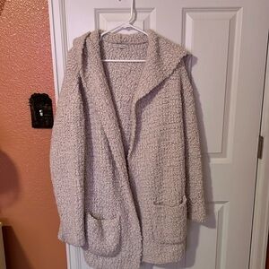 Off white thick jacket that feels like a hug.  Nylon and polyester.